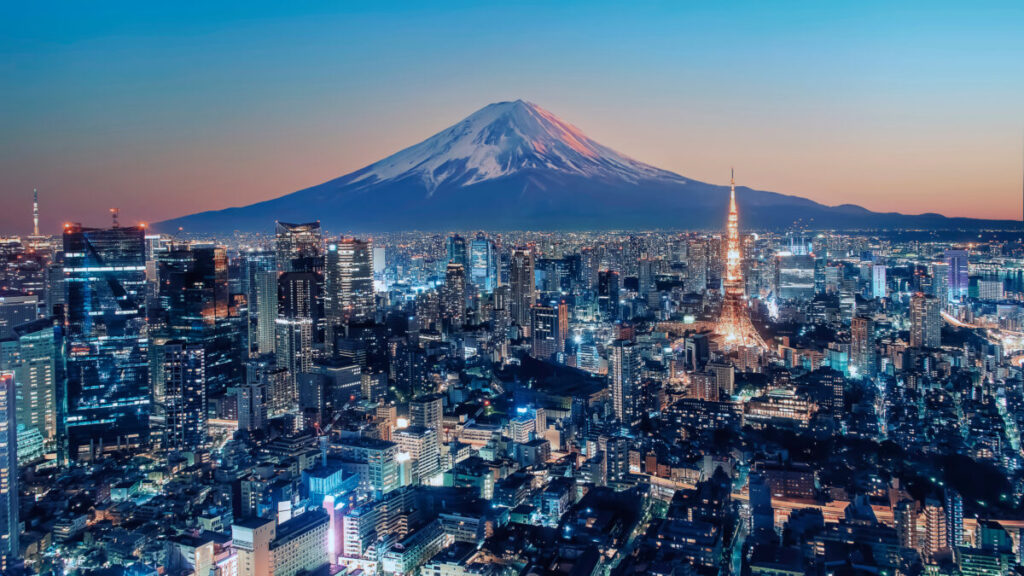 Tokyo skyline at sunset showing modern skyscrapers and traditional temples in harmony