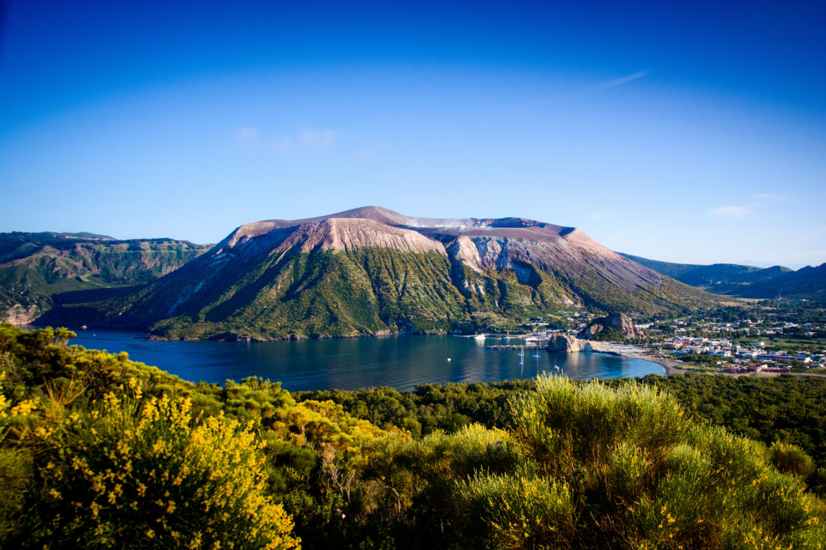 Dramatic volcanic landscape of Vulcano island with steam vents and turquoise waters