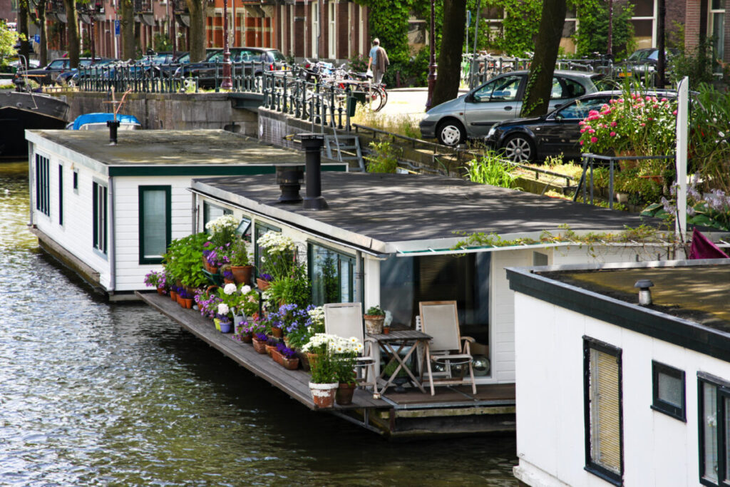 Close-up of an Amsterdam Houseboat with lots of plants and flowers