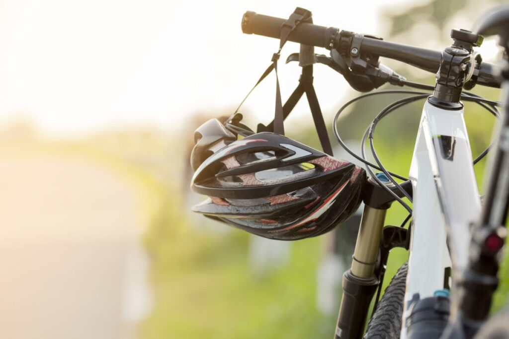 Close-up of a bike helment hanged on the bike handles