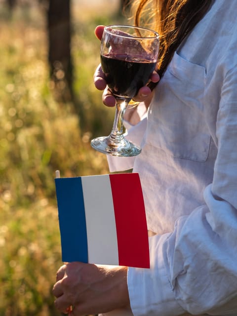 Professional sommelier examining a glass of red Burgundy wine during an educational tasting session