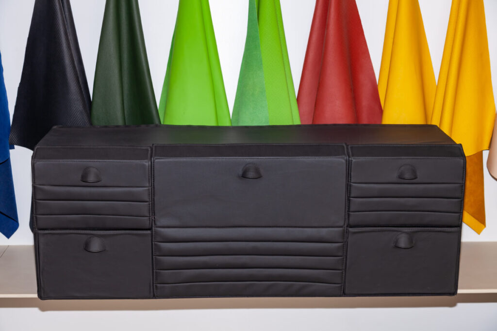 Black leather organizer bag designed for efficient storage in a car trunk 