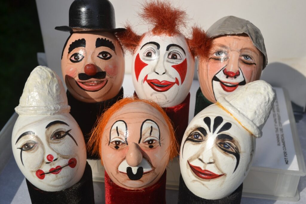Colorful clown art displayed in the Clowns Gallery-Museum in London, showcasing various styles and historical pieces
