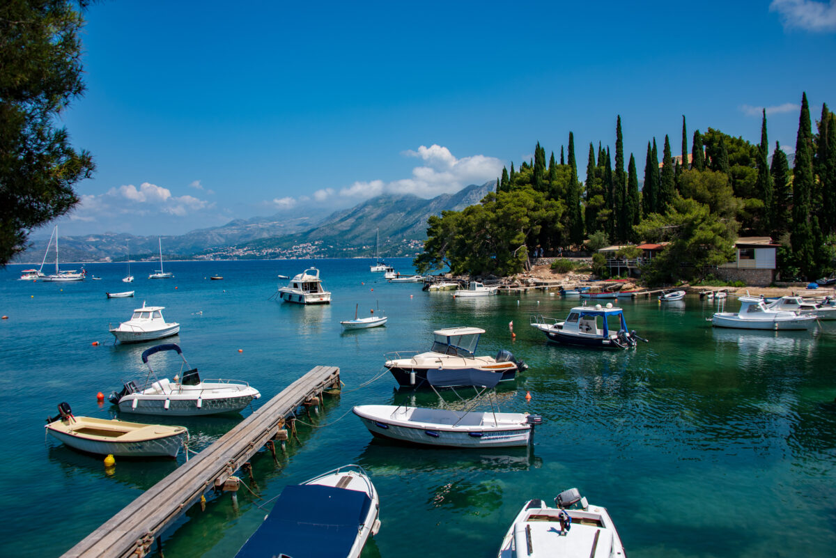 Crystal-clear cove with boats in Cavtat Croatia showcasing Adriatic Sea beauty