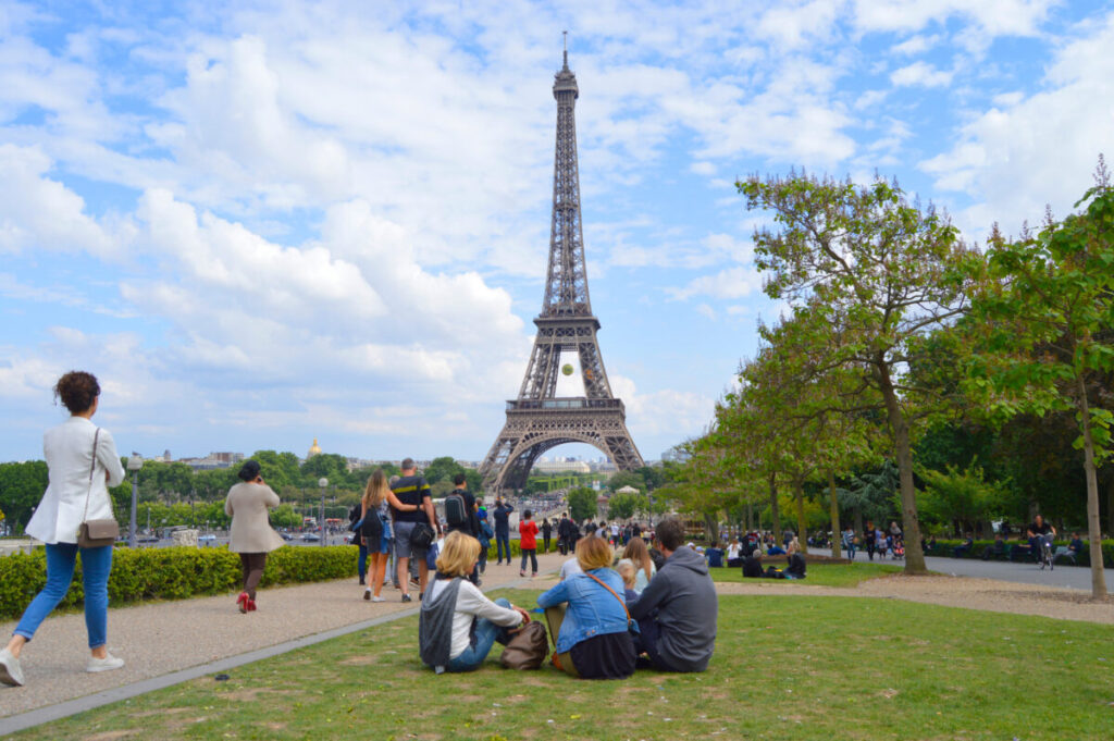 Tourists and locals exploring the Eiffel Tower in Paris, France