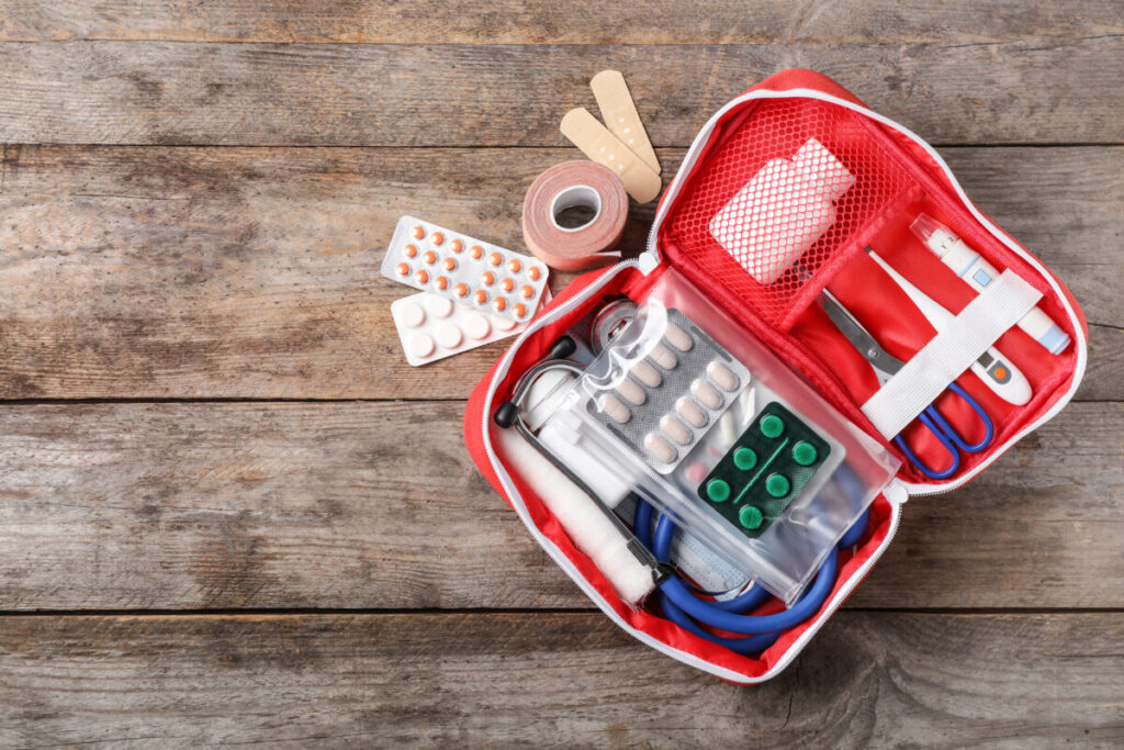 Close-up of an emergency first aid kit on a wooden floor