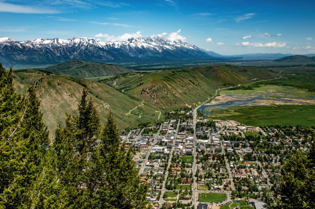 Sunset view over Jackson Hole valley showcasing adventure tour possibilities across mountains and rivers