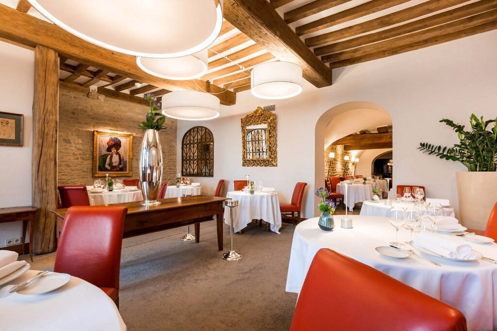 Elegant interior of Maison Lameloise Michelin-starred restaurant showcasing fine dining ambiance