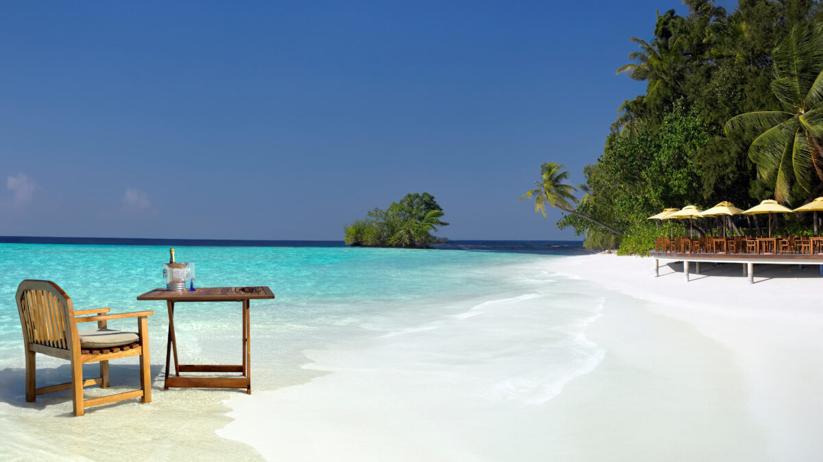 Romantic private beach picnic setup on secluded Maldivian sandbank