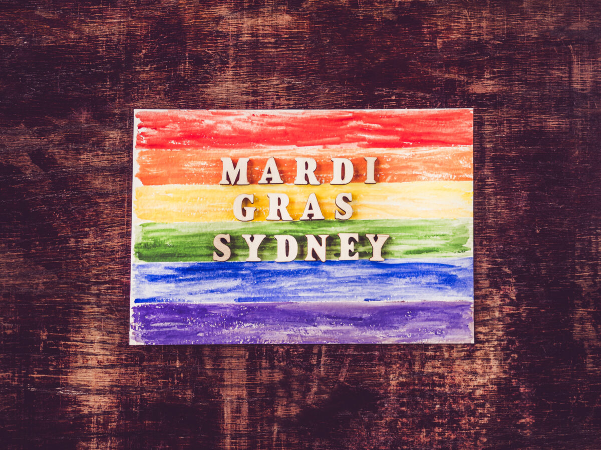 Colorful Sydney Mardi Gras parade with rainbow flags and festive celebrations