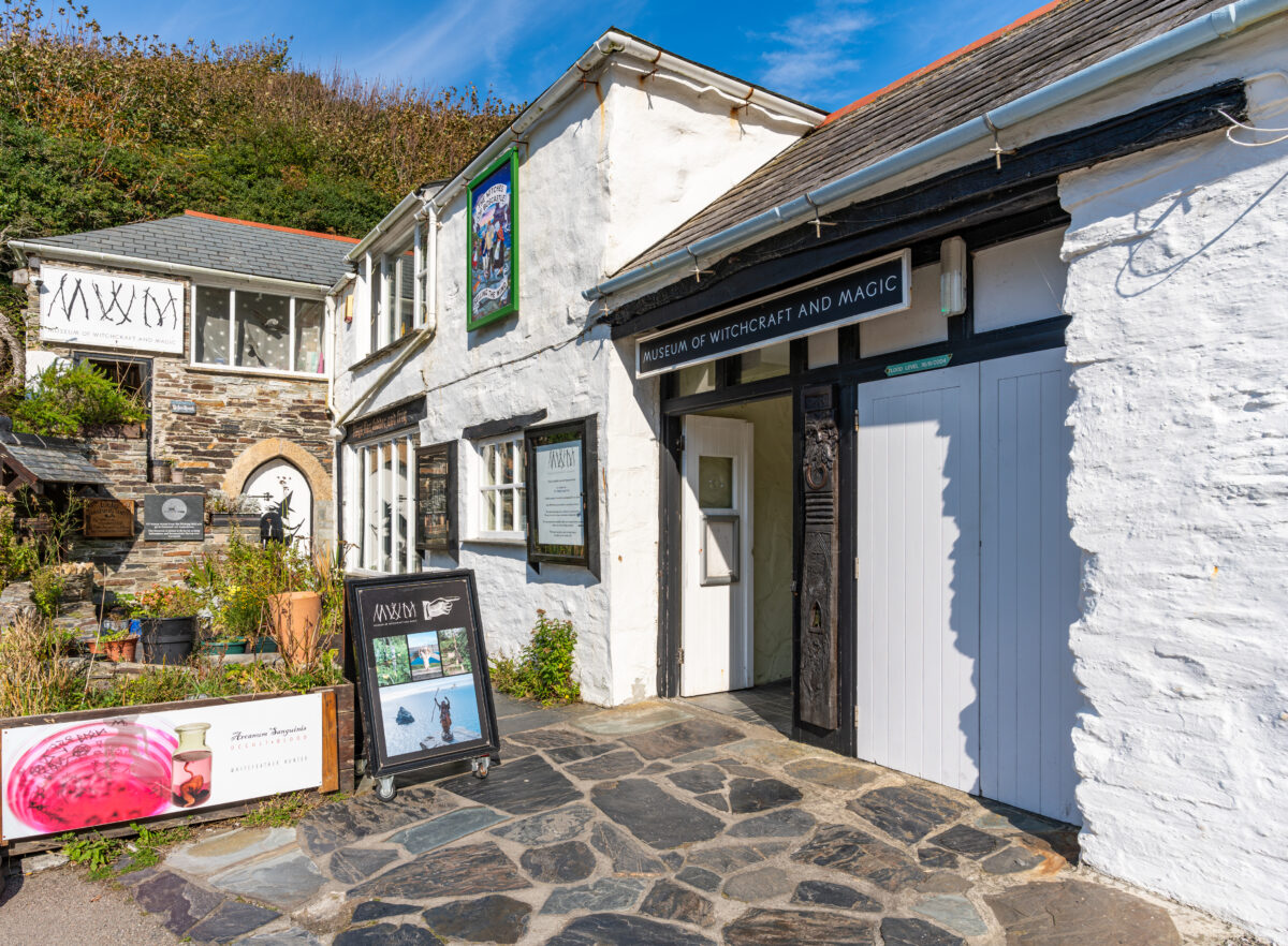 Exterior view of the Museum of Witchcraft and Magic in Boscastle, England, showcasing its entrance and unique architecture.