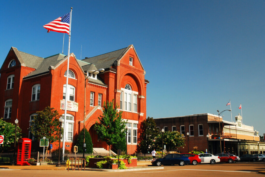 City Hall of Oxford with an American flag and skyline in Oxford, Mississippi