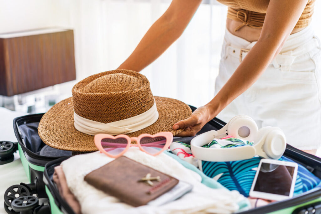 Young traveler packing a suitcase with travel essentials