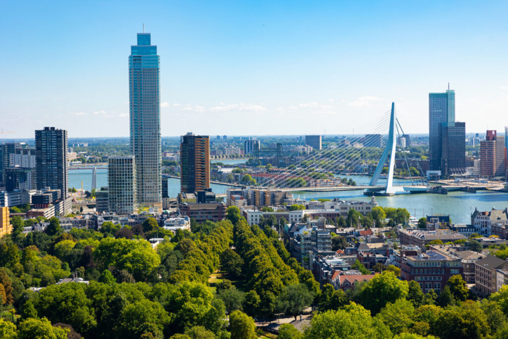 Rotterdam skyline featuring Erasmus Bridge and modern architecture along Nieuwe Maas river