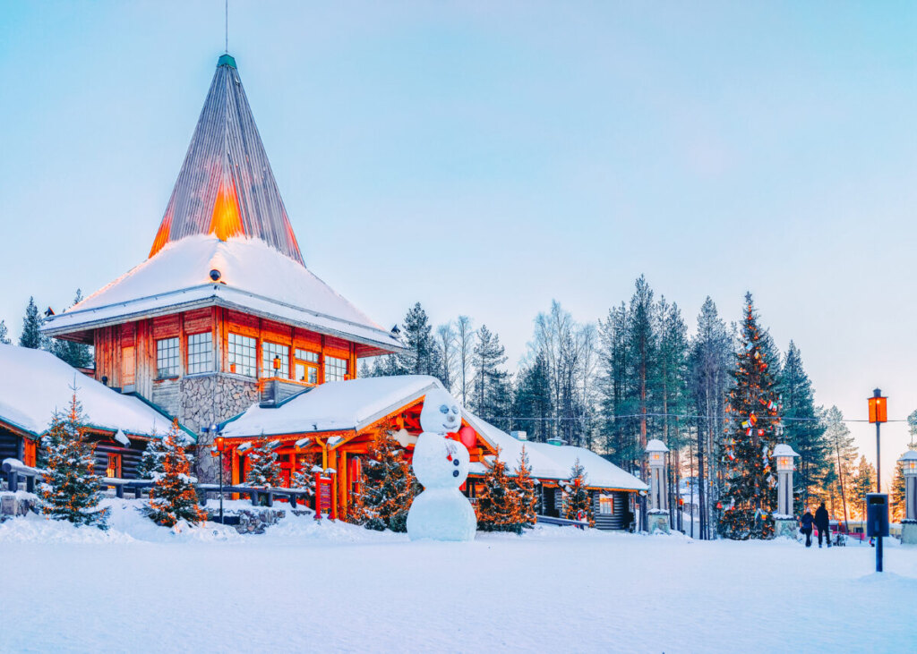 Panoramic view of Santa Office, Christmas trees, and a snowman at Santa Claus Village in Rovaniemi, Lapland, Finland