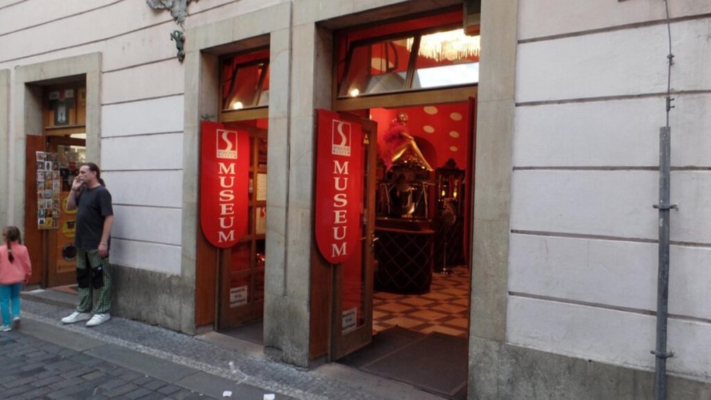 Exterior view of the Sex Machines Museum in Prague, showcasing its unique entrance and vibrant signage.
