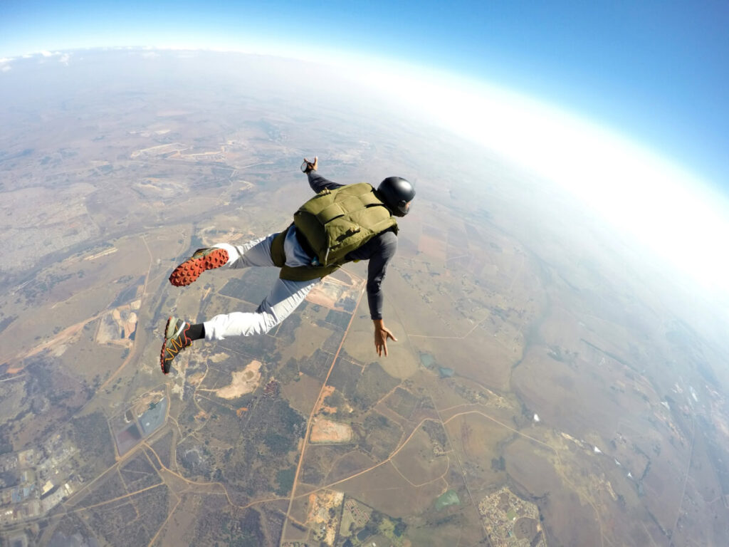 Skydiver skydiving  in action equipped with skydiving gear
