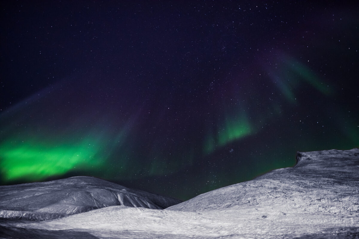 The polar arctic Northern lights aurora borealis sky star in Norway Svalbard in Longyearbyen city the moon mountains