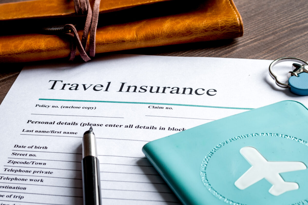 Close-up of a travel insurance application with a pen on top