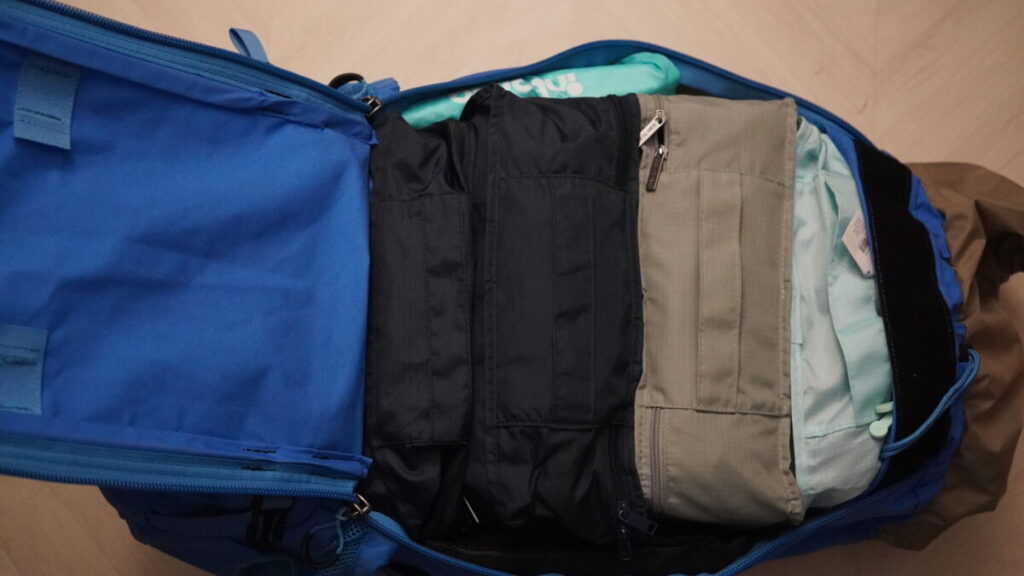 Travel bag with assorted packing cubes in various colors and sizes