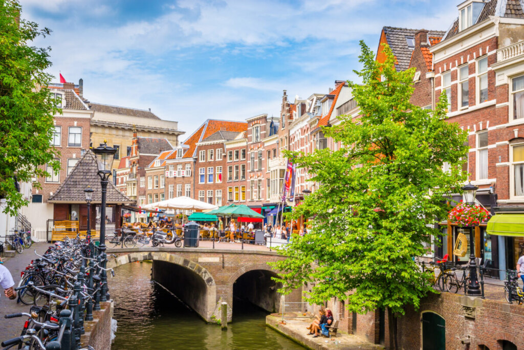Utrecht Netherlands canal view with unique wharf cellars and outdoor cafes along Oudegracht